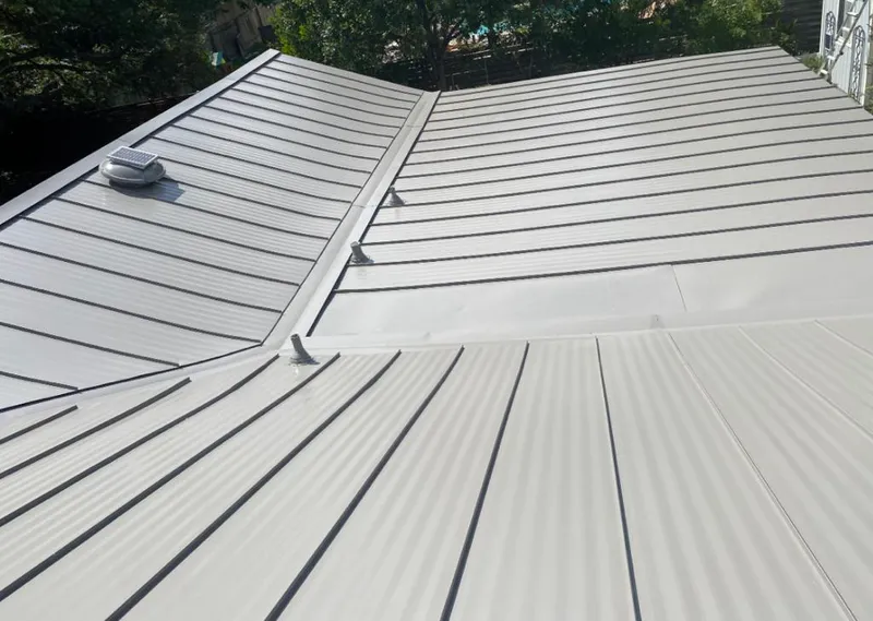 Solar attic fan installed on a metal roof for Roof Ventilation in Central City