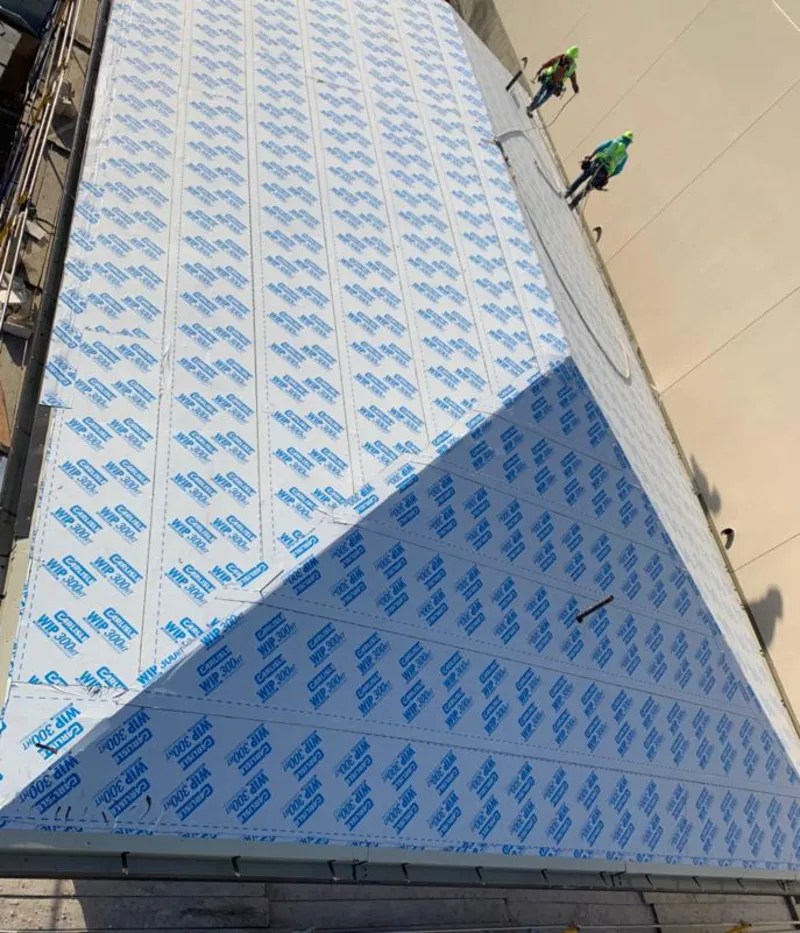 Professional roofers installing underlayment on a metal roof in Central City